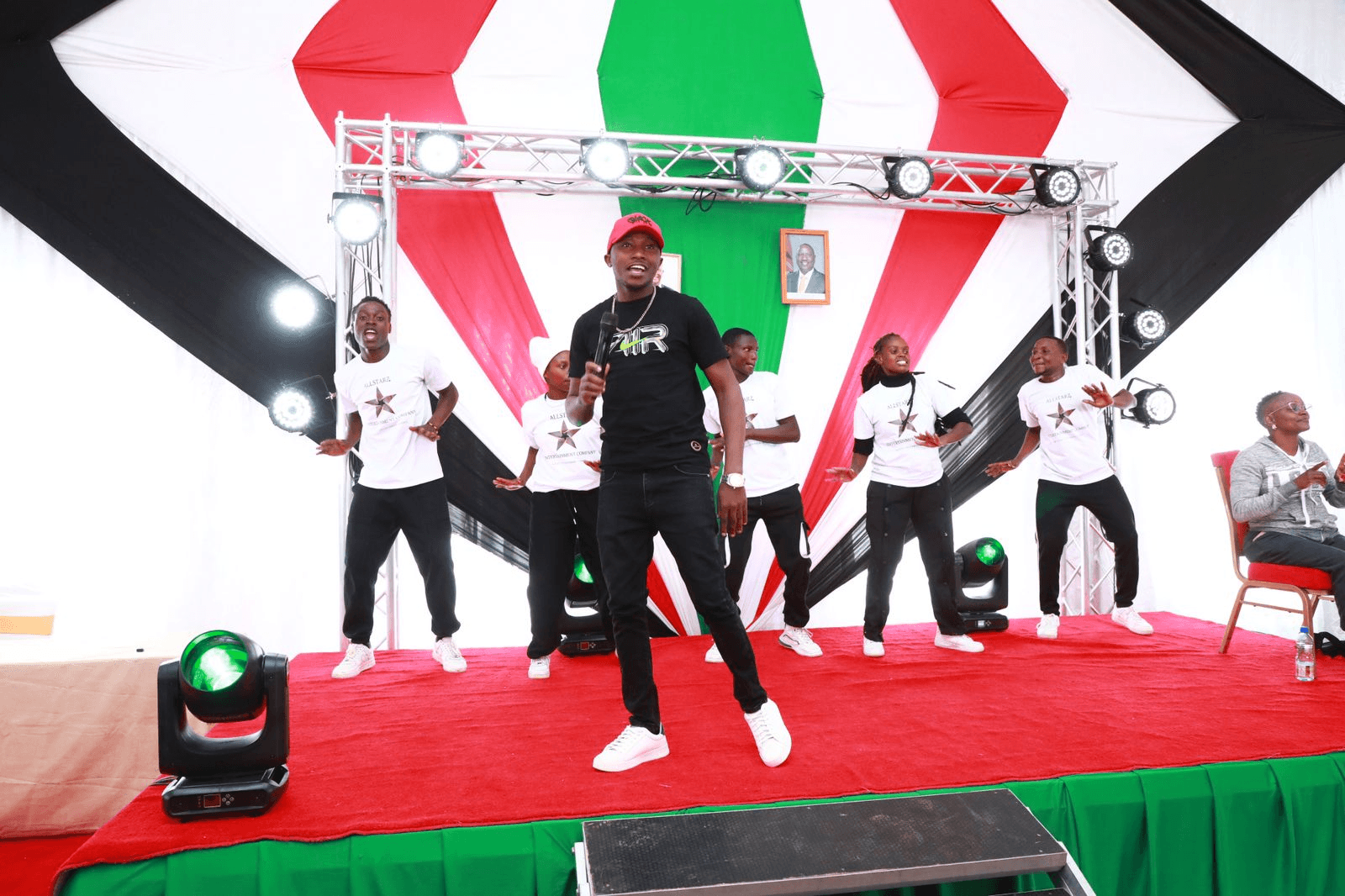 Team members performing on stage together