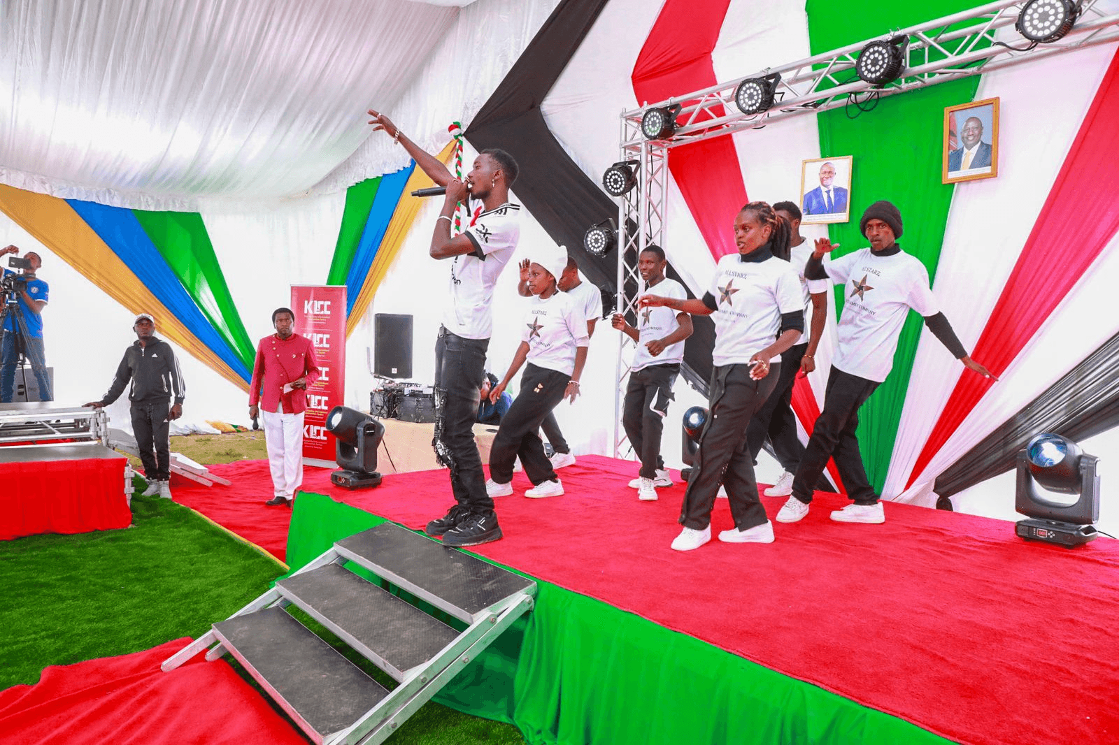 Team members performing on stage together